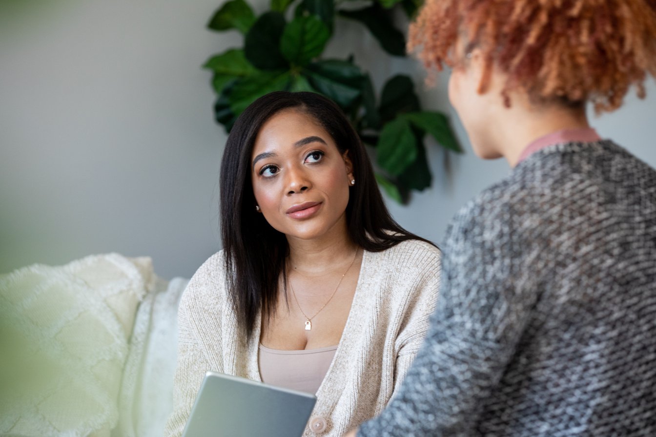 Young woman attends counseling session with therapist or life coach